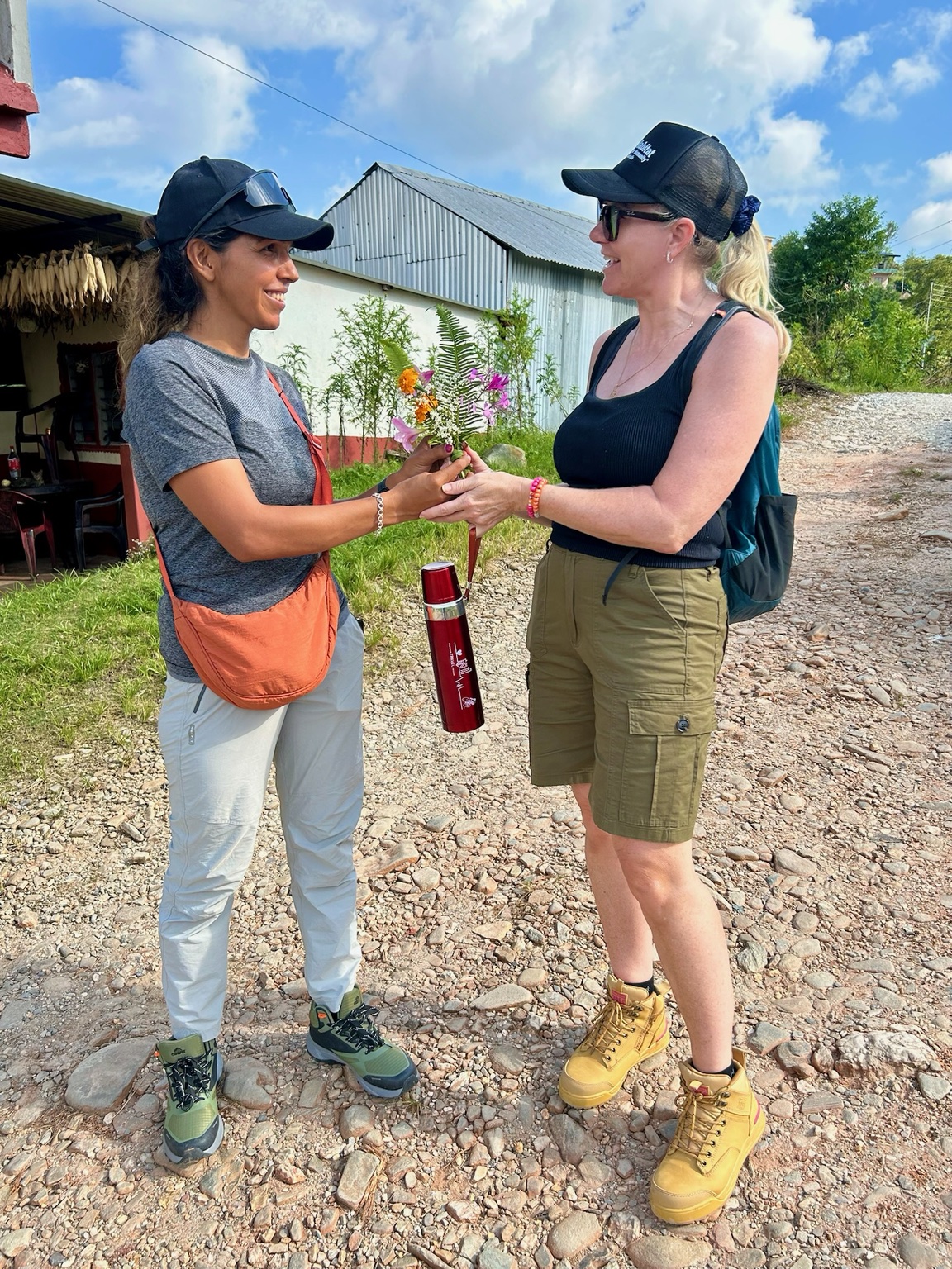 Sital and a trekker celebrating the end of a walk